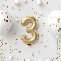 A golden balloon of the number three, against a white background with glitter and other white balloons. Image credit: AdobeStock_833782779 A golden balloon of the number three, against a white background with glitter and other white balloons. Image credit: AdobeStock_833782779