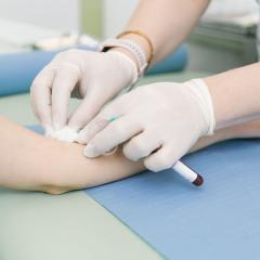A close-up of a healthcare working carrying out a blood test on a patient. Image by Med Ved via Shutterstock.