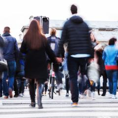 People crossing a city street, who are at greater risk of cardiovascular / heart diseases.