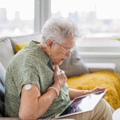 A diabetic woman clutching her heart; cardiac problems are common in diabetes.