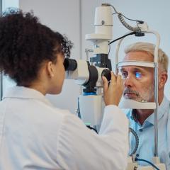 Person undergoing an eye exam. Image credit: People Images - Yuri A via Shutterstock.