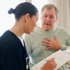 Heart patient filling out a PROM with help from a doctor. Image credit: WesleyJVR/peopleimages.com via Adobe Stock.
