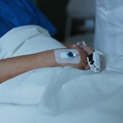 A patient in a bed, getting hospital care at home.