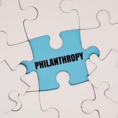 A white jigsaw with a missing piece - the word 'philanthropy' is written in the gap. Image by My Stockers via Shutterstock.