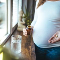 Pregnant woman using medication. Image by Dragana Gosic via Shutterstock. 