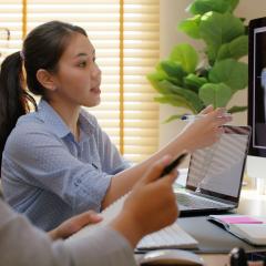 Researchers working with a computer scan. Image credit Chay_Tee via Shutterstock