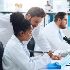 Scientists working together. Image credit SiphosethuFan via Adobe Stock.
