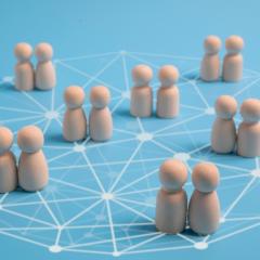 Image via Shutterstock Pairs of wooden figures on a network pattern. Image via Shutterstock