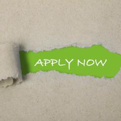 Most of the image is rough brown paper. In the centre, this is ripped away to reveal the words 'apply now' written in white on a green background. Original image by Marta Design via Shutterstock, modified by IHI.