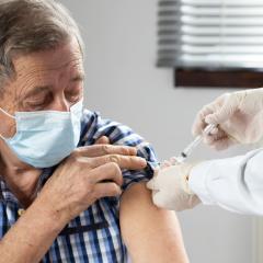 Elderly man getting a vaccine. Image by Melinda Nagy via Shutterstock.