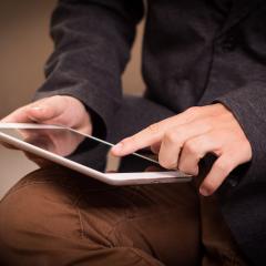 A man using a tablet. Image by Niek Verlaan via Pixabay.