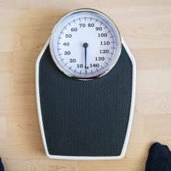 The tool helps patients understand how their weight loss trajectory is likely to change following surgery. Image by Maren Winter via Shutterstock. A black analogue scale lying on a pale wooden floor. We can just see a person's toes at the bottom of the picture. Image by Maren Winter via Shutterstock.