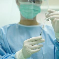 Woman preps vaccine by PIJITRA PHOMKHAM via Shutterstock