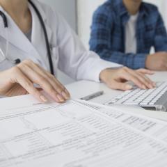 Health worker data entry by Leonardo Da via shutterstock