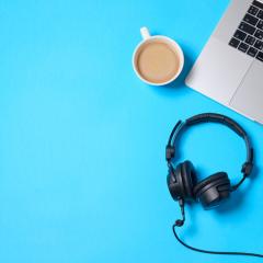 Image by Boiarkina Marina via Shutterstock A laptop keyboard, headphones, microphone and a cup of coffee are viewed from above. The background is bright blue. Image by Boiarkina Marina via Shutterstock.